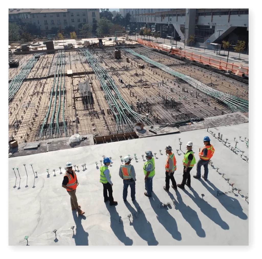 workaware - workmen standing in front of construction site